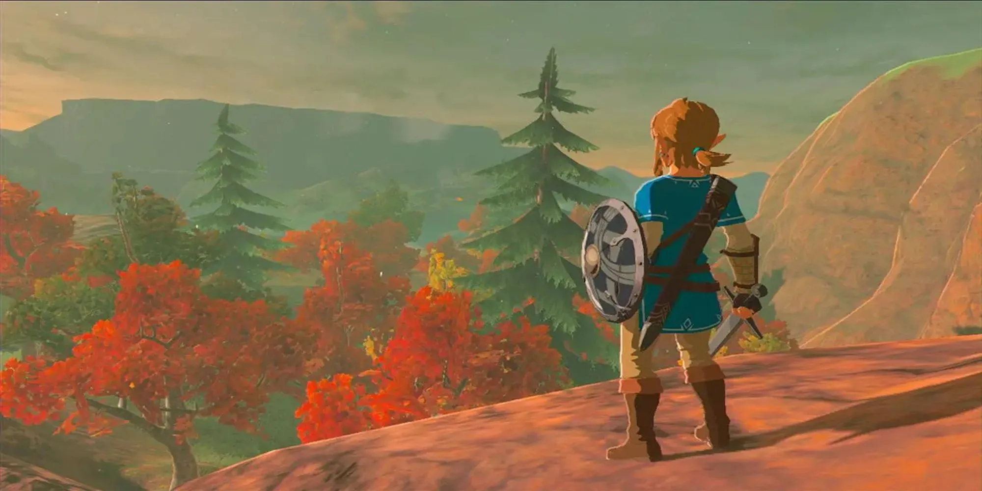 Link nhìn xuống từ một vách đá trong The Legend of Zelda: Breath of the Wild với phong cảnh Hyrule rộng lớn