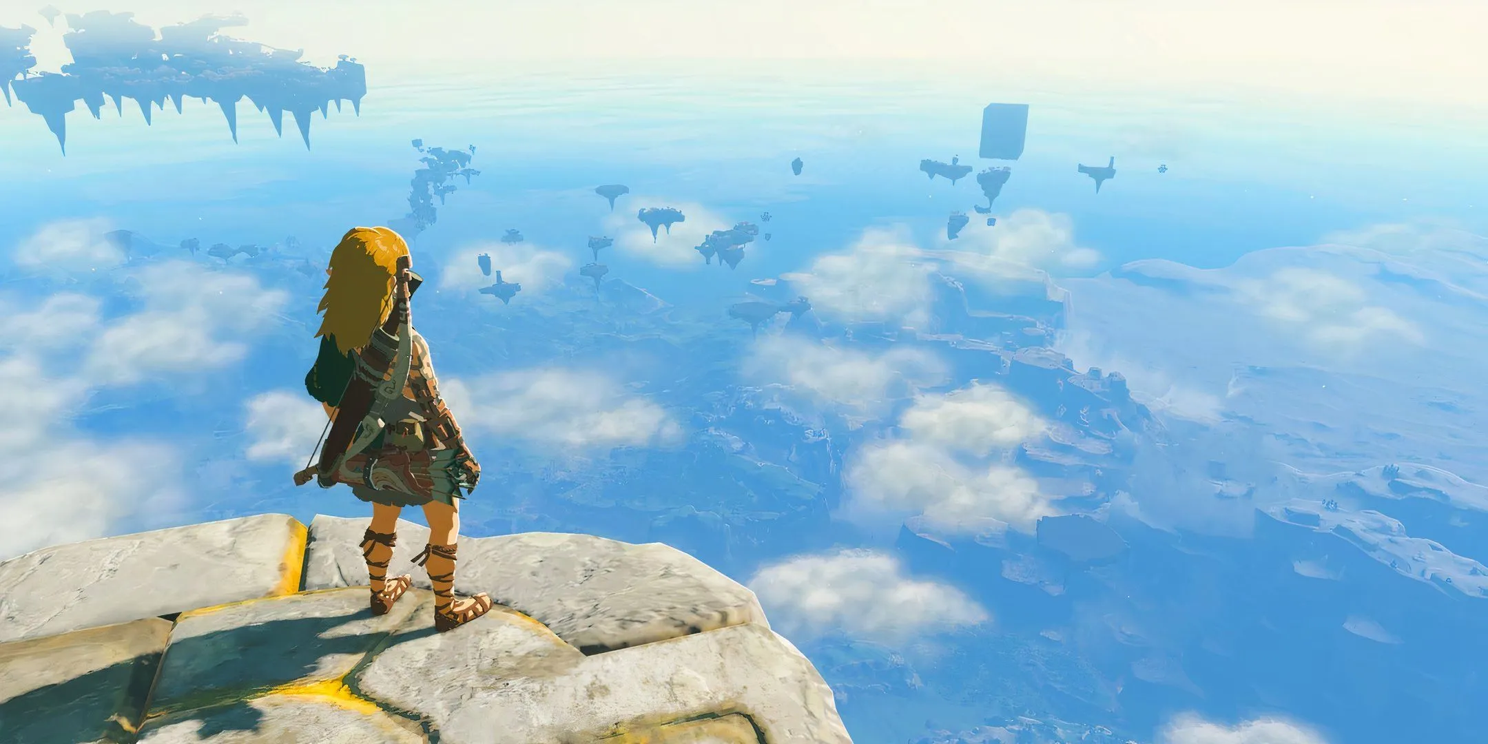 Link nhìn xuống Hyrule từ Đảo bay trong The Legend of Zelda: Tears of the Kingdom, tượng trưng cho fan cứng.