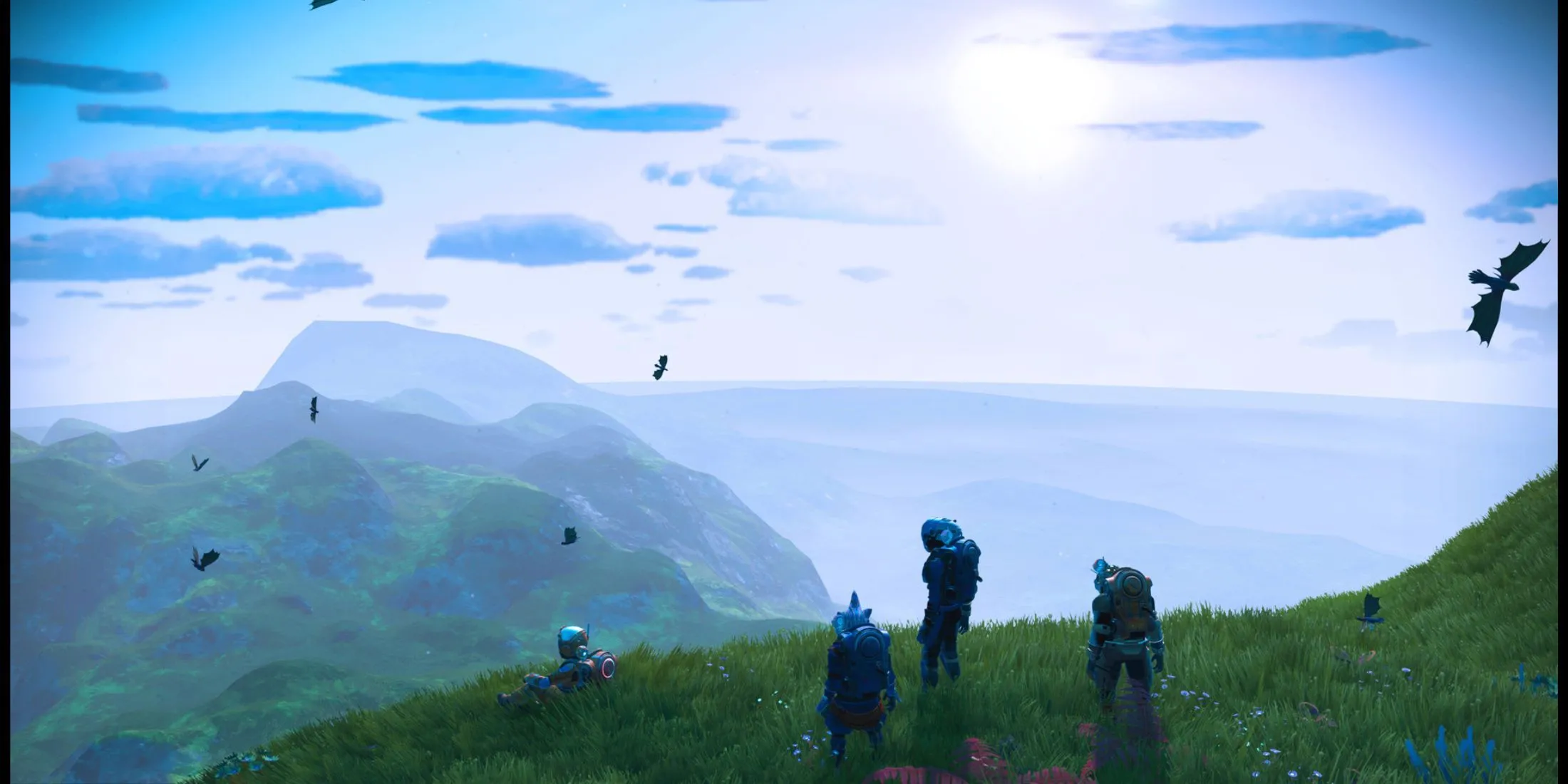 Một nhóm người chơi khám phá địa hình núi non rộng lớn trong vũ trụ No Man's Sky